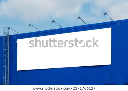 Mock up template. Big horizontal white blank signboard, advertising billboard on modern building wall outdoors