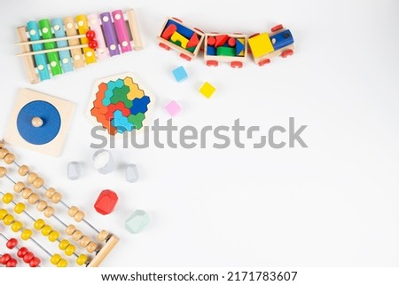 Baby kids colorful educational and musical toys on white background. Top view, flat lay frame
