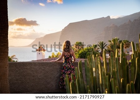 woman looking at sunset over the ocean in  Tenerife Canary islands Royalty-Free Stock Photo #2171790927