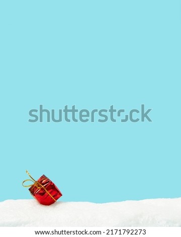 Christmas decoration gift on the snow with blue background. New year concept background idea.