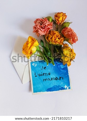 Happy Mother's Day greeting card. Lettering I love mom in french. Flat lay. selective focus