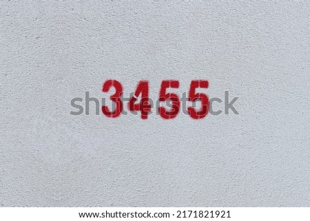 Red Number 3455 on the white wall. Spray paint.
