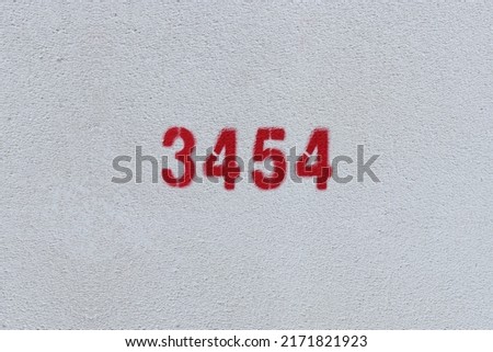 Red Number 3454 on the white wall. Spray paint.
