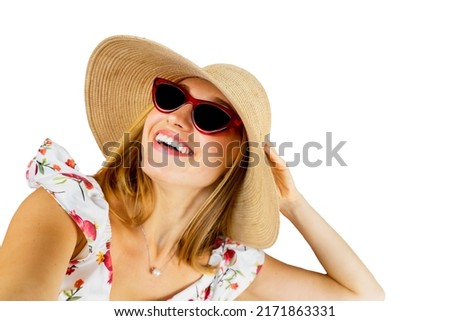 Close up of smiling woman wearing hat and sunglasses while taking a photo selfie in the studio