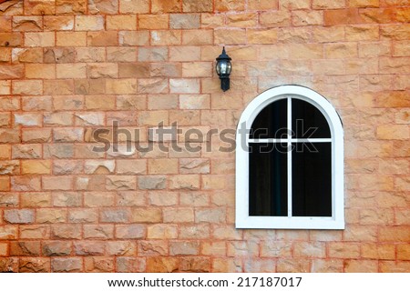 white window frame classic shape and lamp on the brick wall 