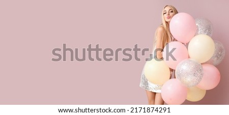 Pretty young woman with balloons on pink background with space for text Royalty-Free Stock Photo #2171874291