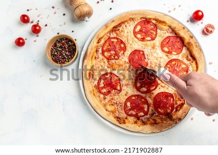 slices of pizza margherita. Pizza margarita and hand close up. Food recipe background.