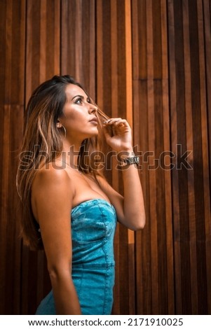 Portrait of a beautiful brunette girl on a background of wooden boards, lifestyle, summer, vertical photo