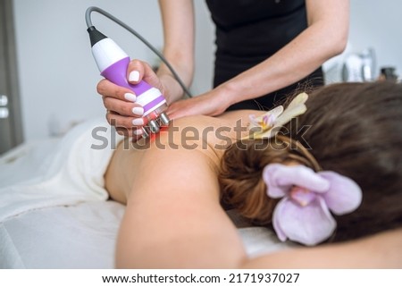 Hardware figure correction with vacuum her back massage. Overweight treatment, body sculpting. Royalty-Free Stock Photo #2171937027