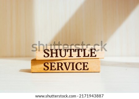 Wooden blocks with words 'shuttle service'. Business concept