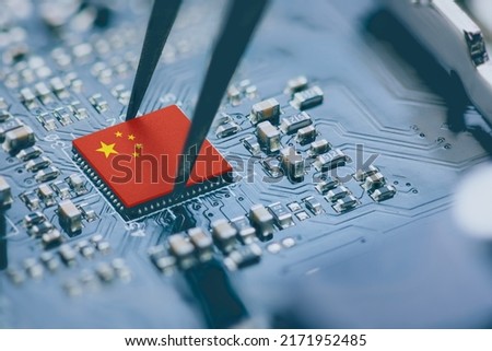 Flag of China on a processor, CPU Central processing Unit or GPU microchip on a motherboard. China is world's largest chip manufacturer, demonstrating the country's superiority in global supply chain. Royalty-Free Stock Photo #2171952485
