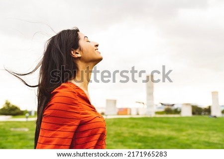 pretty ethnic indian woman, breathe fresh air, calm millennial ethnic lady take a deep breath with closed eyes meditate feel good zen