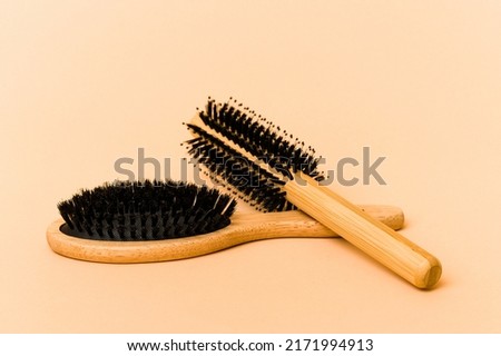 Two types of hairbrush isolated on beige background Royalty-Free Stock Photo #2171994913