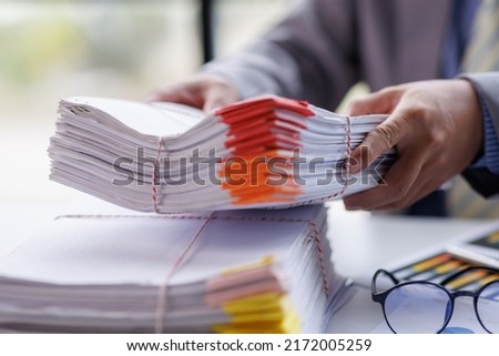 Business Documents, Auditor businesswoman checking searching document legal prepare paperwork or report for analysis TAX time,accountant Documents data contract partner deal in workplace office Royalty-Free Stock Photo #2172005259