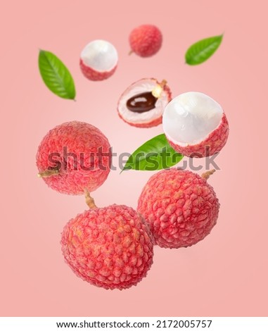 Lychee fruit flying in the air isolated on pink color background. Royalty-Free Stock Photo #2172005757