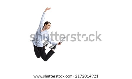 Portrait of young woman, office worker posing with notes in a jump isolated over white studio background. Concept of business, office lifestyle, success, ballet, career, expression, ad