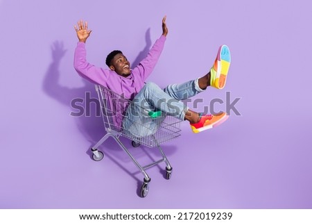 Full length body size view of attractive carefree cheery guy riding cart having fun isolated over vivid violet lilac color background Royalty-Free Stock Photo #2172019239
