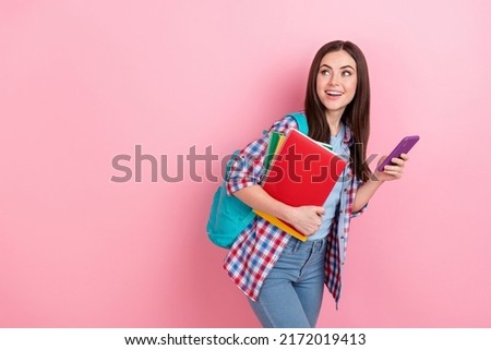 Photo of amazed cheerful girl look blank space see promotion go campus courses isolated on pink color background