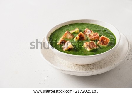 Palak Paneer served with chapati and basmati rice isolated on white background. Indian vegetarian cuisine made of spinach and paneer cheese. Royalty-Free Stock Photo #2172025185