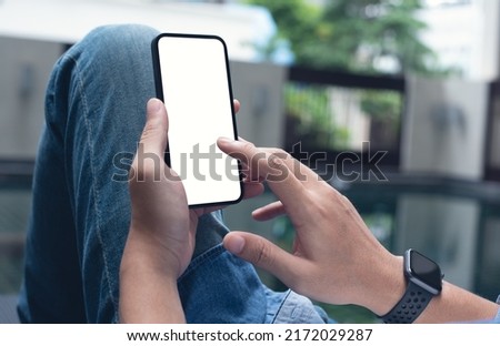 Mockup image of mobile phone for advertising. Mock up image of man hand holding and using smartphone with blank screen for mobile app design, people lifestyle