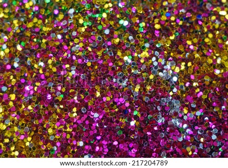 Small multicolored sequins as background, unfocused                 