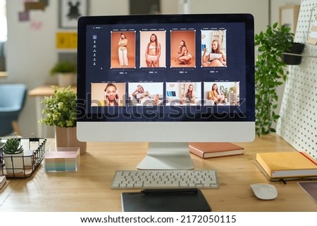 Desktop computer with photo editing software on desk