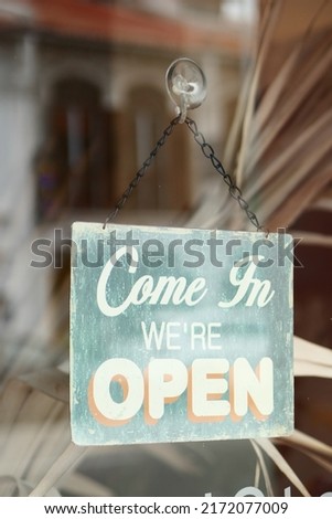 Open sign hanging front of cafe .
