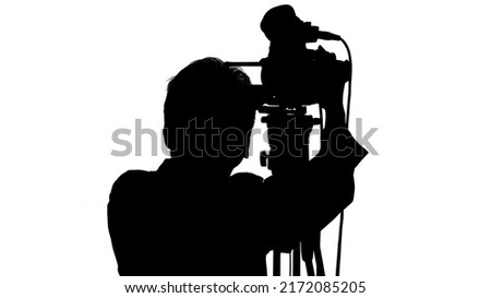 Video camera operator isolated on white background. Focus on screen.