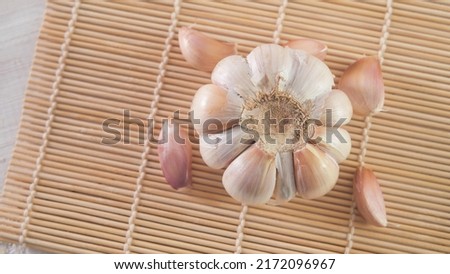 garlic on a wooden board in selective focus