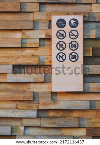 Various wooden public building and shopping center information signs on wooden wall background in vertical frame