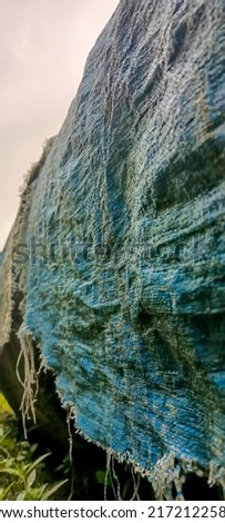 blue carpet that has been damaged with age