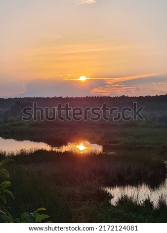 Fantastic summer sunsets over meadow