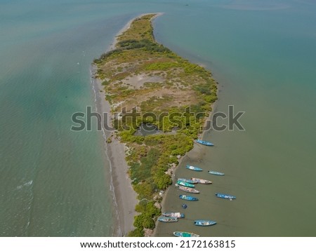 drone shot aerial view top angle bright sunny day beautiful island seascape coastal area beaches forest trees turquoise blue water tourism destination India tamilnadu road highway boats sea ocean 