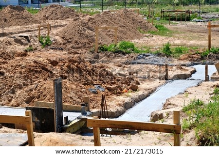 
photo showing a construction site with foundations
