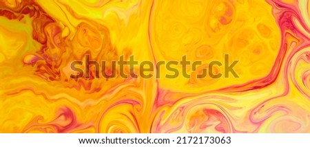 Fluid Art. Abstract liquid orange-red colors paint background. Trendy golden orange backdrop. Liquid art concept