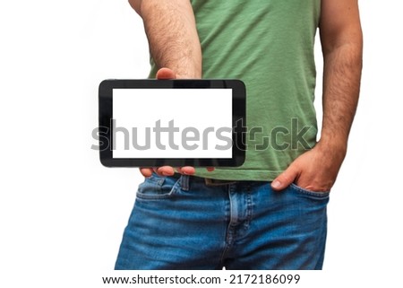Unrecognizable casual dressed man holding tablet with right hand on white isolated background