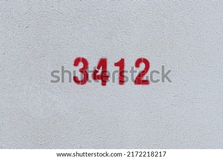 Red Number 3412 on the white wall. Spray paint.

