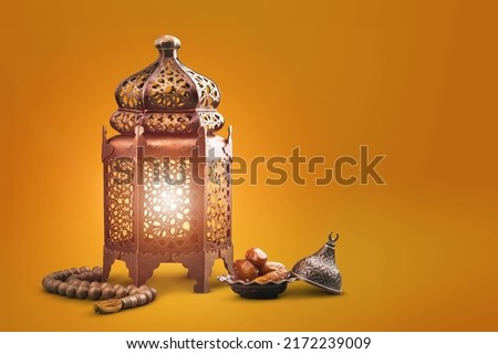 Fawanis. Traditional Ramadan lantern with prayer beads on background. Royalty-Free Stock Photo #2172239009
