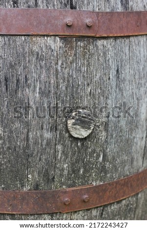 Closeup of a vintage hooped old wine wooden barrel.  