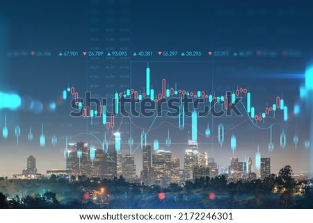 Illuminated Skyline panorama of Los Angeles downtown at night, California, USA. Skyscrapers of LA city. Glowing forex candlesticks hologram. The concept of internet trading, brokerage and analysis