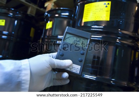 Man checking radiation with geiger counter Royalty-Free Stock Photo #217225549