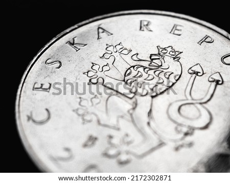 Translation: Czech Republic. National currency of Czechia. Czech one crown coin. Silver double-tailed lion close-up. Illustration for news about economy or finance. Macro