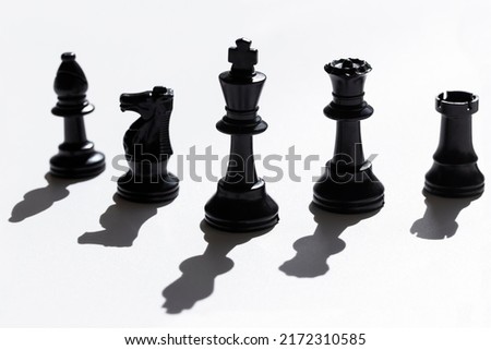 Light and shadow Set of black chess pieces.