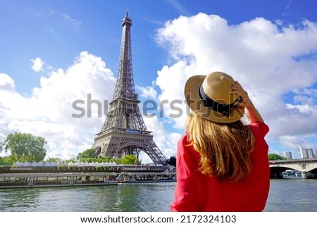 Holidays in Paris. Back view of beautiful fashion girl enjoying view of Eiffel Tower in Paris, France. Summer vacation in Europe. Royalty-Free Stock Photo #2172324103