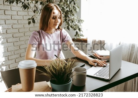Young female graphic designer drawing with graphic tablet in office