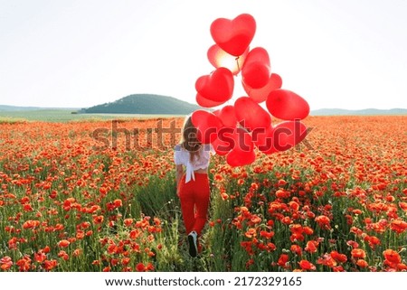Happy woman holding balloons in nature. High quality photo