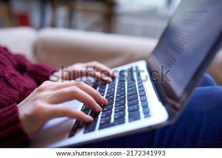 Beautiful woman relaxing at home with notebook