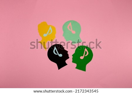 3 male heads and one female with a brain of musical notes, creative party design, listening to music. pink background