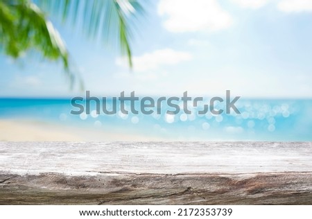 Empty wooden table on blurred tropical sea and sky background