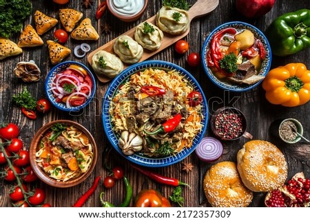 Uzbek and Central Asia cuisine concept. Assorted Uzbek food pilaf samsa lagman manti shurpa Uzbek restaurant concept Uzbek food. Food recipe background Royalty-Free Stock Photo #2172357309